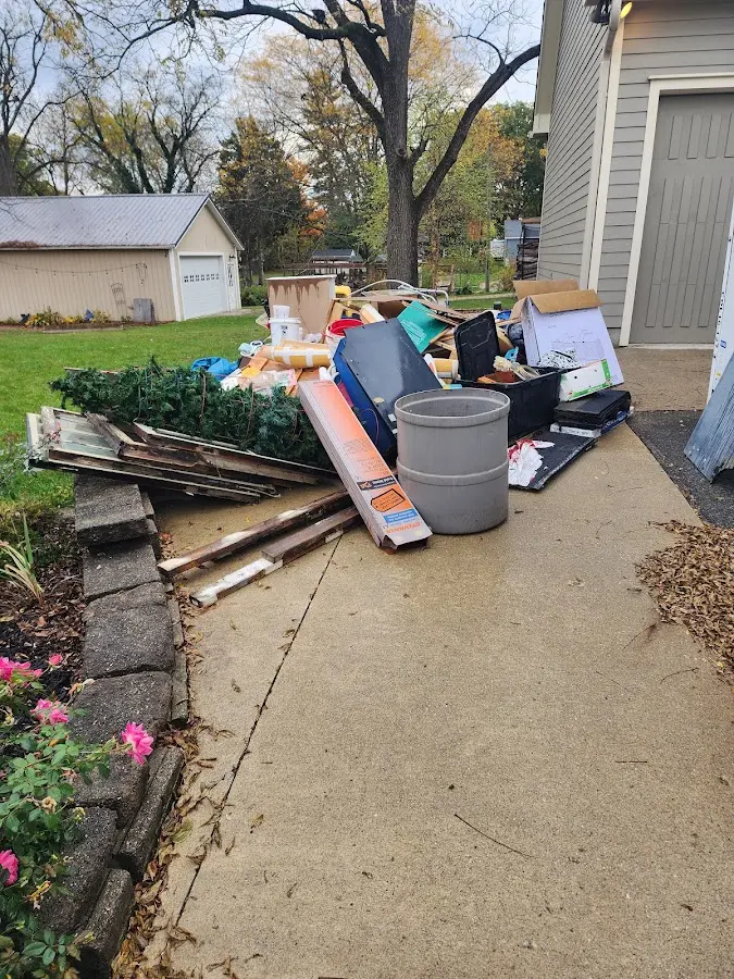 Dumpster being loaded with debris for Estate Cleanout Dumpster Rental in Pine City